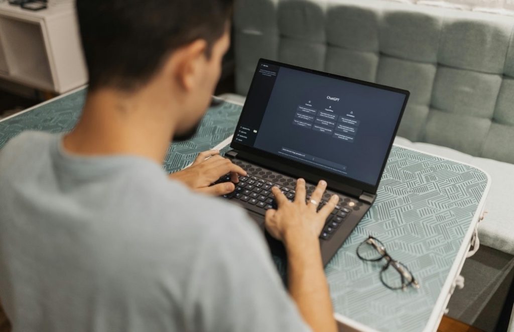 Hands typing code into a laptop