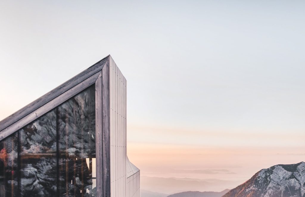 Modern wooden structure beneath an evening sky